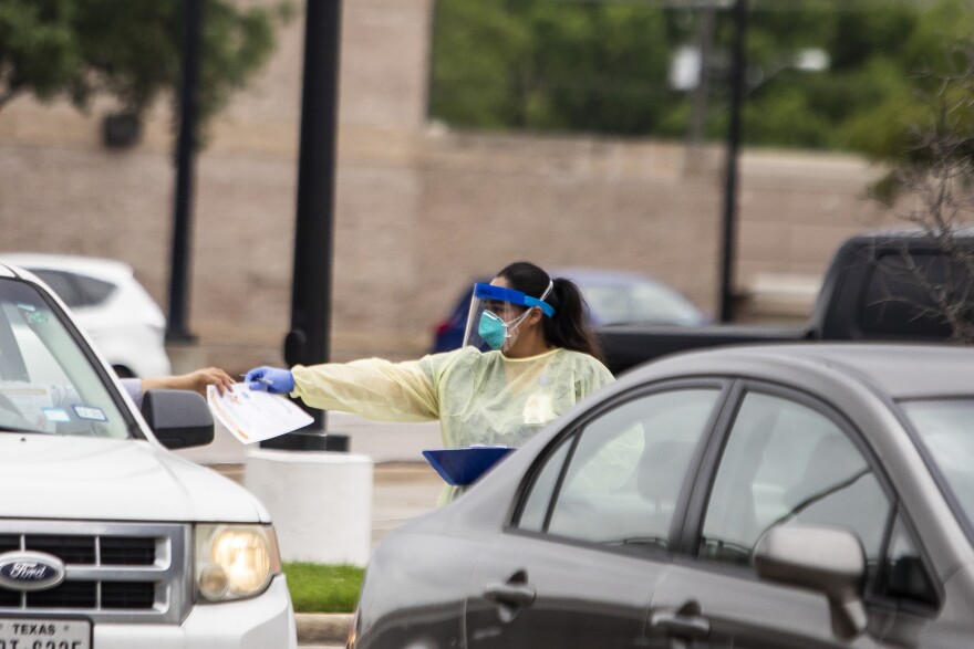 Drive-thru COVID-19 testing takes place at the CommUnityCare in Hancock Center in March.