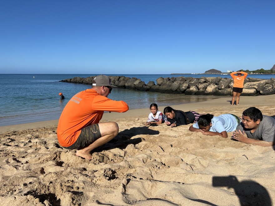 A Nā Kama Kai instructor teaches keiki the foundational skills of ocean safety and respect.