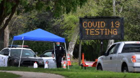 A police officer mans the entrance to a coronavirus (COVID-19) testing center in Hansen Dam Park in Pacoima, California.