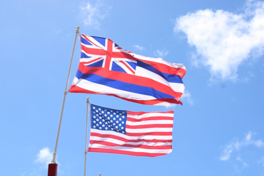 The U.S. flag is captured next to the Hawaiʻi state flag on Maui.
