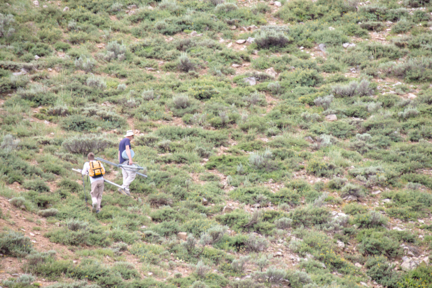 Hungarian scientist András Dobos, left, and Utah State University graduate research assistant Tim Wright climb the edge of a basin in Logan Canyon to install a temperature sensor on July 29, 2026.