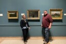 Erin Damon, Head of Collections, and Mike Brown, Director of Sustainability, at the Portland Museum of Art, standing with a painting by Winslow Homer.