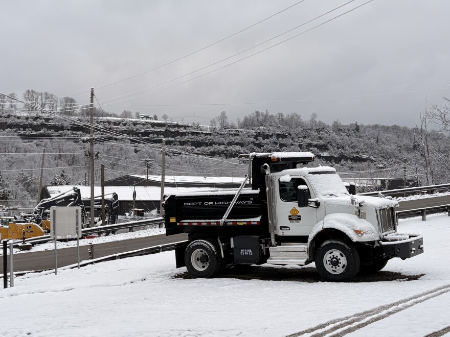 A Kentucky Transportation Cabinet truck sits under a light layer of snow at the KYTC Division of Equipment Facility in Frankfort, where Governor Andy Beshear, Transportation Secretary Jim Gray, and Kentucky State Police Trooper Bryan Washer held a press conference Tuesday morning.