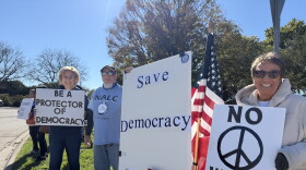 Lynn Solontoi and Eric Oberg of Monmouth and Vanessa Bell of Galesburg at the No Kings: Vote Early rally in Galesburg.