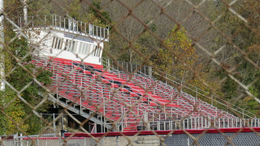 the stands of a sports stadium seen through a fence