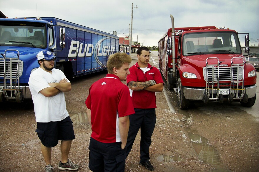 Beer delivery truck drivers wait in Whiteclay on Monday as protesters block their way. Liquor stores in the town sell millions of cans of beer annually to residents of the reservation.