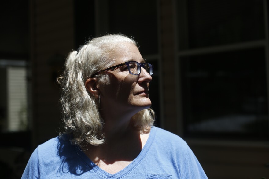 Melissa Preen stands beside boxes filled with her belongings as she prepares to move back to Cleveland, Ohio. She says she can no longer afford to live in Country Villa Estates in Riverview, Florida, due to rising lot rent and other fees.