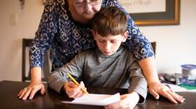 Noah, a fifth grader in West Valley School District, works with his grandmother Sherry Kirksey on math at the kitchen table as school doors remain closed during the coronavirus pandemic. 