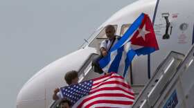 Clueless on Cuba: Passengers wave U.S. and Cuban flags while deplaning from a JetBlue flight from Miami to Santa Clara, Cuba, in 2016.