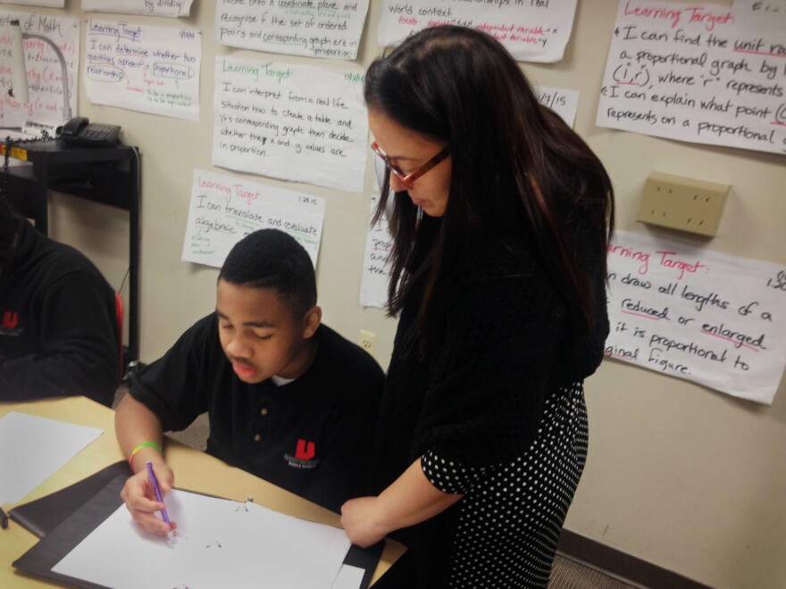 Teacher Jennifer Bahns helps her seventh-graders work through algebraic equations that, before the Common Core, were taught in eighth or ninth grade.