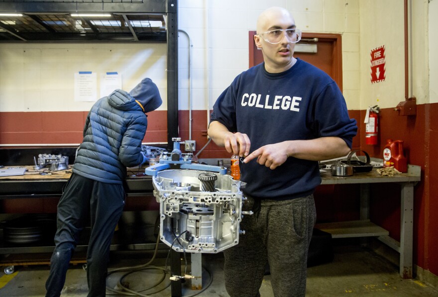 Matthew Dickinson, 21, asks a classmate for help as they rebuild an automatic transmission in an auto repair technician program classes at the Lake Washington Institute of Technology.