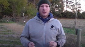 Screenshot of online video showing Christopher Arthur demonstrating military survival tactics.