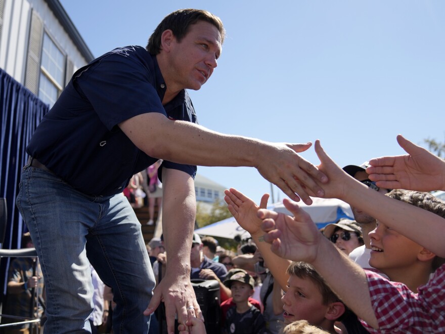 Republican presidential candidate Florida Gov. Ron DeSantis shakes hands with fairgoers at the Iowa State Fair, August 12 in Des Moines, Iowa.