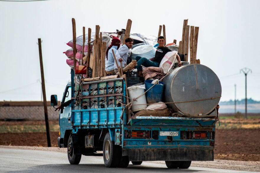 Syrian Kurdish and Arab families are pictured fleeing in the countryside of the town of Darbasiyah, on the border between Syria and Turkey, towards the town of Hassakeh on October 22, 2019. (Delil Souleiman/Getty Images) 
