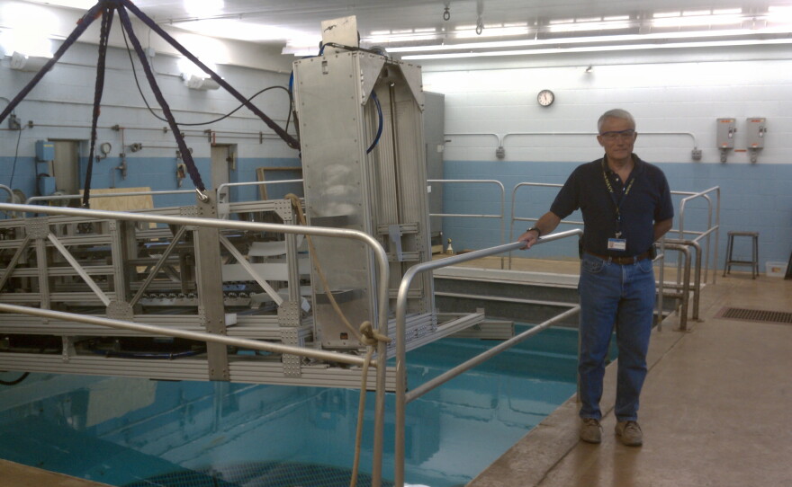 Woody Cook, Battelle National Security, next to a pool that is used to test underwater robotic devices.