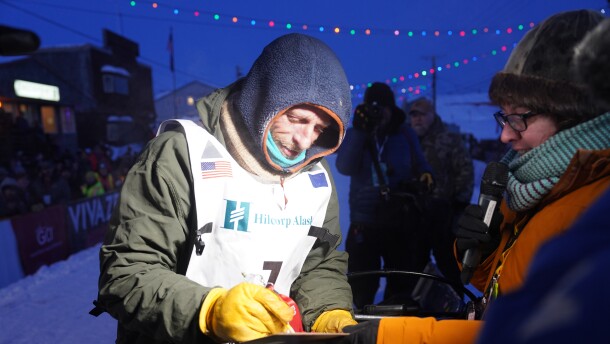 Iditarod Trail Sled Dog Race champion Jessie Holmes signs in after finishing the 1,000-mile race in Nome the evening of Tuesday, March 17, 2026.