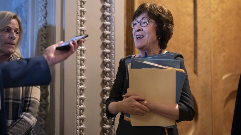 Sen. Susan Collins, R-Maine, chair of the Senate Appropriations Committee, pauses in the door to the chamber to answer a question from a reporter as the Senate works to avert a partial government shutdown ahead of the midnight deadline, at the Capitol in Washington, Friday, March 14, 2025.