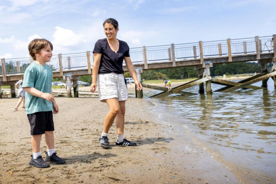 Meaghan Rogers and her son, Bode, on the beach at Iron Horse Park in Hingham, Mass. (Robin Lubbock/WBUR)