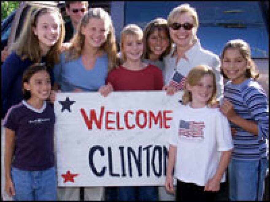 Hillary Clinton poses with local residents outside the Skaneateles, N.Y., home where the Clintons were staying in August 2000. The Clintons took their summer vacation in upstate New York that year.