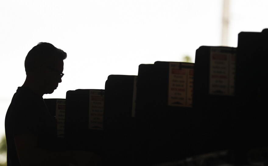 A voter cast his ballot at the Miami-Dade County Palm Springs North Fire Station, during the Florida primary election, Tuesday, Aug. 28, 2018, in Miami. 