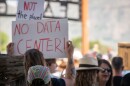 A protester waives a "No Data Center" sign outside of a special meeting of the Box Elder County Commission at the BEC Fairgrounds in Tremonton, May 4, 2026.