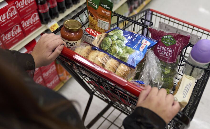 Jaqueline Benitez, who depends on California's SNAP benefits to help pay for food, shops for groceries at a supermarket in Bellflower, Calif., on Feb. 13, 2023.