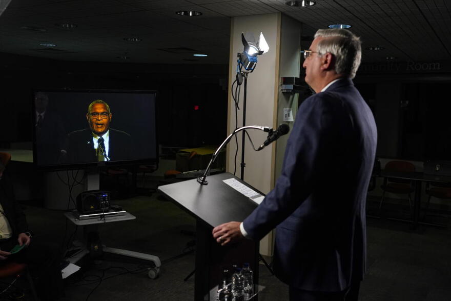 Due to COVID-19 precautions, the three gubernatorial candidates and the moderator were in separate rooms at WFYI studios in Indianapolis. Here, Republican Gov. Eric Holcomb watches Democrat Dr. Woody Myers speak.