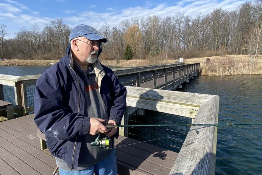 Dan Morris casts a fishing line into the lake at Crego Park in Lansing. "I can't go ice fishing, so I might as well try this," said Morris. An avid ice fisherman, he's only been out once this year.