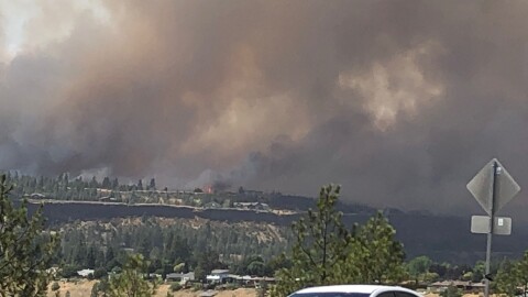 The Old Trails fire is visible across the Spokane River from Northwest Boulevard.