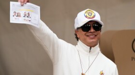Colombian President Gustavo Petro shows a ballot during the runoff election in Bogota, Colombia, Sunday, June 21, 2026.