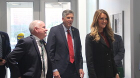 Local and federal officials enter a university building.