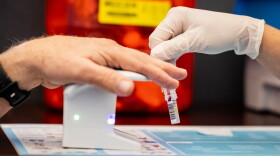 Pharmacy technician Bristelle McCullough, right, administers a BetterWay blood test to a patient at Lake Hills Pharmacy in August.