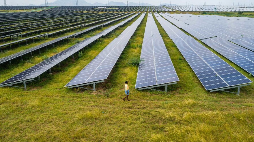 The report finds the world's energy supply needs to shift to renewable sources, like this solar farm in Karnataka, India, but it's not happening fast enough.