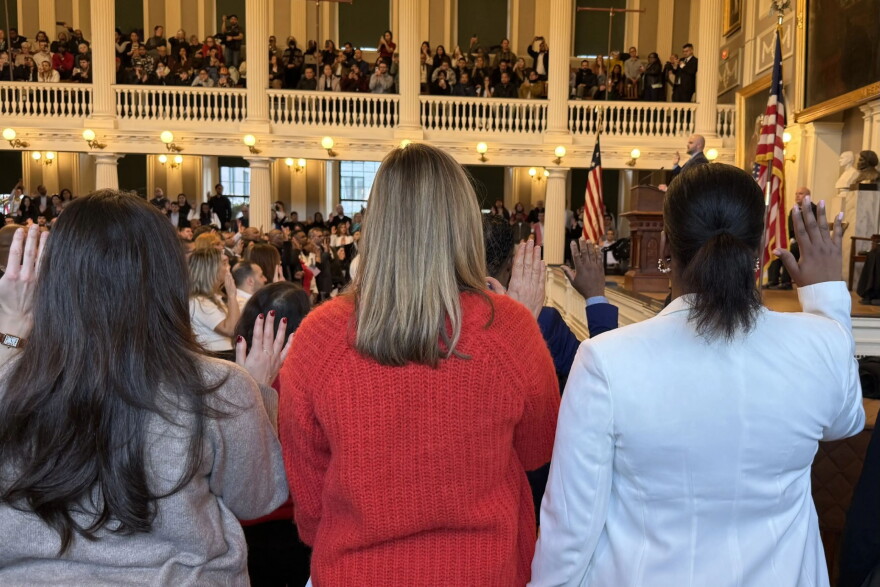 A group of women take the oath of citizenship at Faneuil Hall in January 2026.
