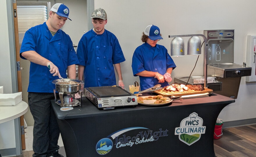 Students from the Culinary Arts program serve lunch to event guests.