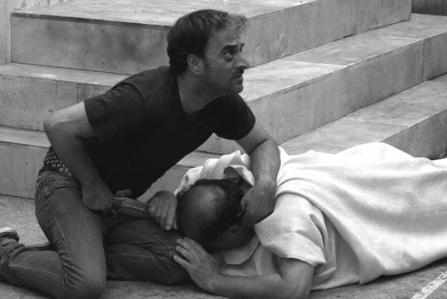 Brutus (Salvatore Striano) delivers the final blow to the dying Caesar (Giovanni Arcuri) during a performance of Shakespeare's <em>Julius</em> <em>Caesar </em>in the film <em>Caesar Must Die.</em>