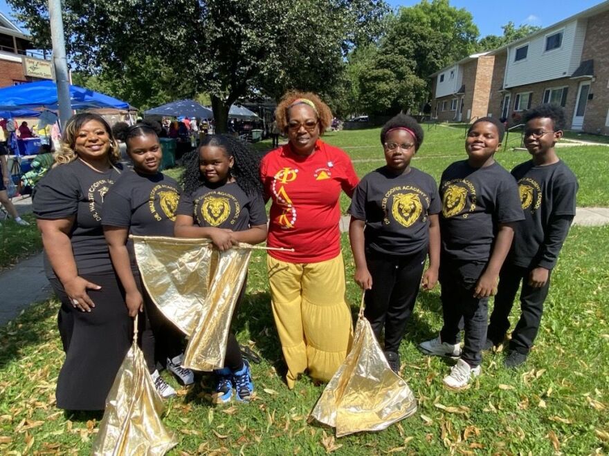 Eva Thomas – Principal, Dr. Walter Cooper Academy School No. 10, with some of her students who performed a cultural dance at the Clarissa Street Reunion.