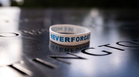 A 'Never Forget' wrist band is left on the 9/11 Memorial.
