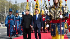 After crossing the demarcation line, Kim and Moon walk to the official welcome hall for the first North-South summit in more than a decade.