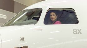 Gov. Sarah Huckabee Sanders looks out the cockpit window of a Falcon business jet on Dec. 12, 2023, after Dassault Falcon Jet CEO Thierry Betbeze announced the French company would invest “tens of millions” in its Little Rock facility and 800 jobs.