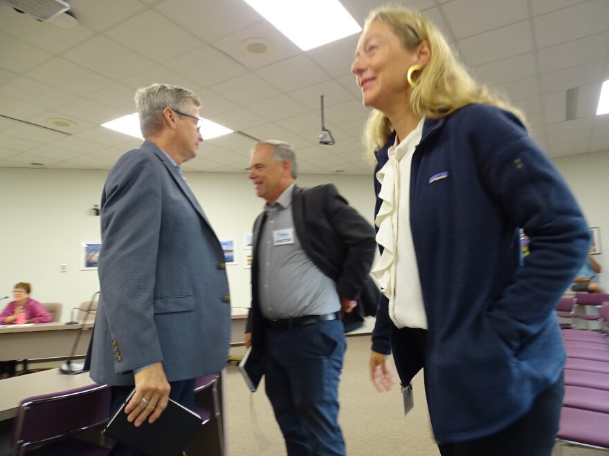 Members of Jacobs team quietly celebrate the news at close of ad hoc committee meeting.