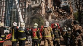 Ukrainian firefighters work on a destroyed building after a drone attack in Kyiv on Monday, amid the Russian invasion of Ukraine.