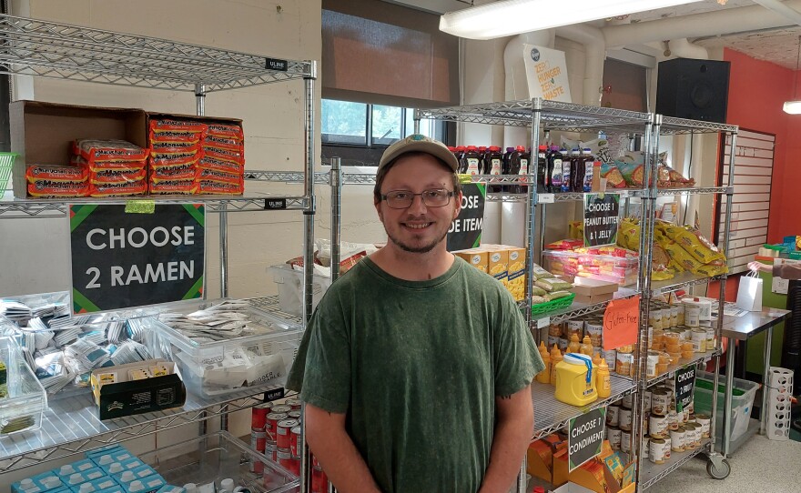 EMU Graduate Assistant Colton Rays helps manage Swoop's Pantry.