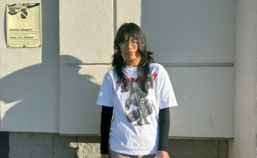Rue Jimenez Acosta stands outside of Goodwill before her shift starts.
