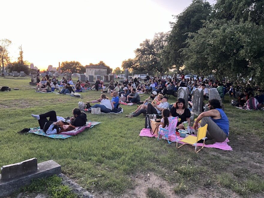 Locals spread blankets among the tombstones to take in a movie at East Side Cemeteries