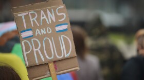  A protester in Kansas City carries a sign with students from Crossroads Preparatory Academy on April 13, 2022 who walked out of class to protest anti-LGBTQ bills in the Missouri legislature.