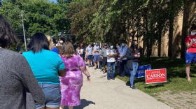 Voters stand in line waiting to vote outside of the Broad Ripple High School building.
