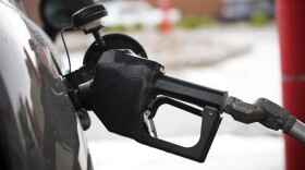 The handle from a gasoline pump hangs from the filler neck of a motorist's vehicle at a Shell station Saturday, July 31, 2021, in Englewood, Colo. Prices paid by U.S. consumers jumped in December 2021 compared to a year earlier, the latest evidence that rising costs for food, gas, rent and other necessities are heightening the financial pressures on America's households. (AP Photo/David Zalubowski)
