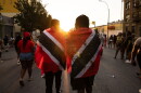 FILE - People with Trinidad and Tobago flag are seen during J'ouvert celebration, Sept. 4, 2023, in the Brooklyn borough of New York.