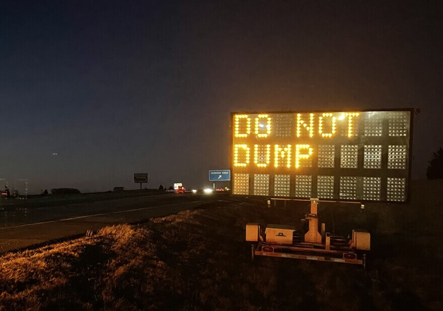 A sign on I-35 near the Stillwater exit warns drivers to not dump their grain trailers.